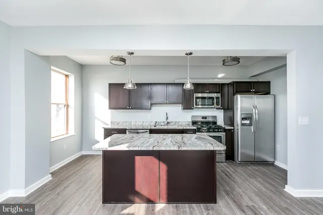a kitchen with a stove a sink and a refrigerator