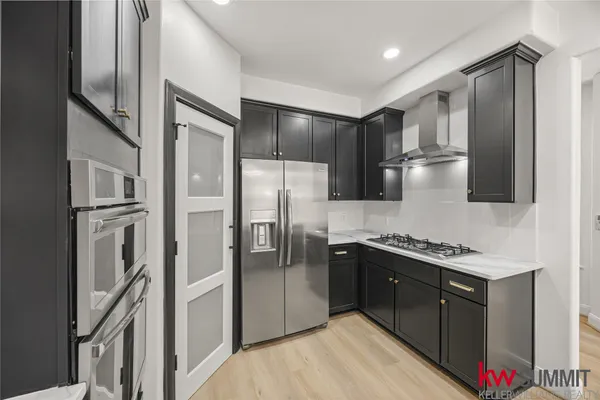 a kitchen with stainless steel appliances granite countertop a refrigerator and a sink