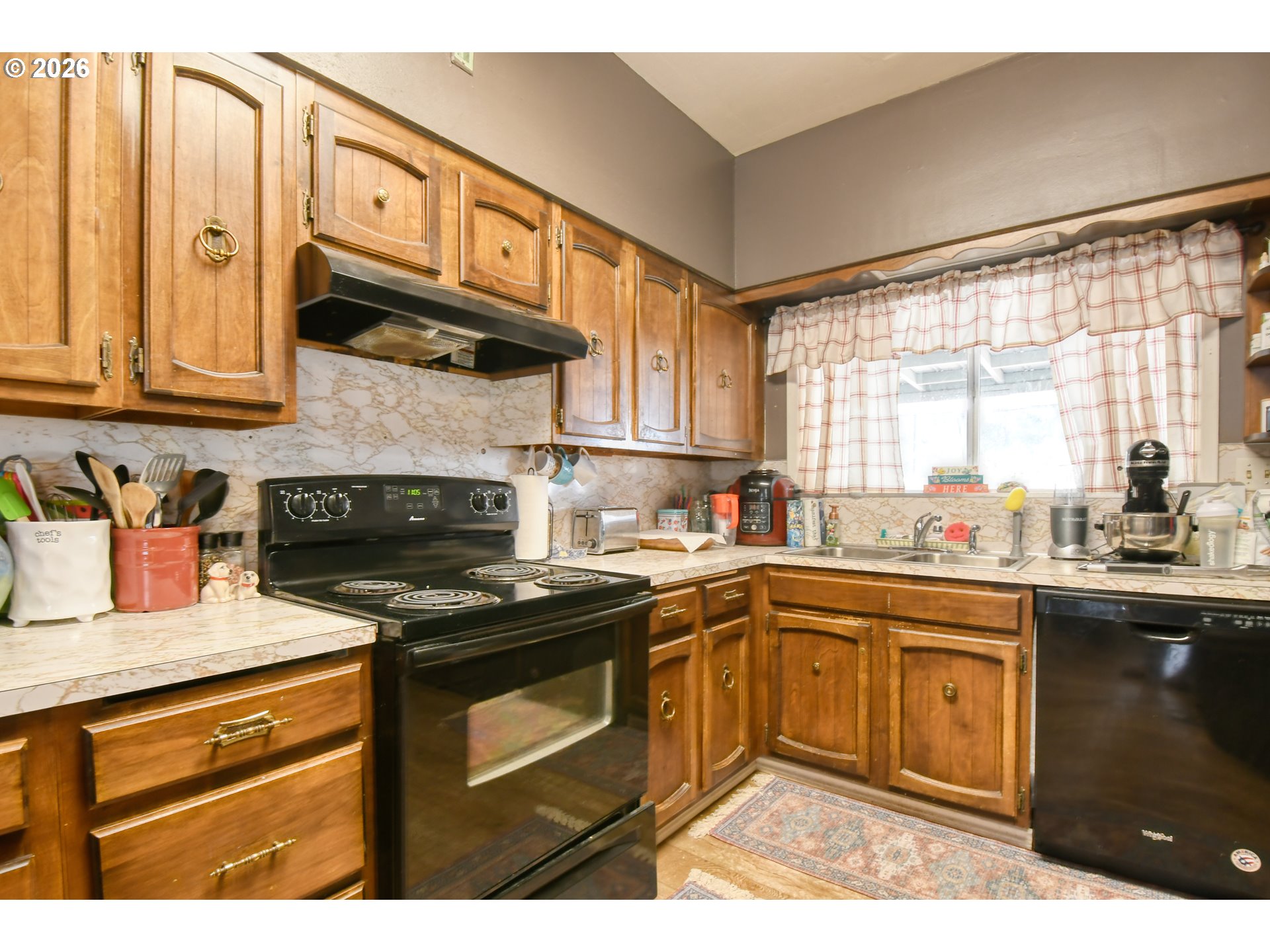 607 Southwest Court Avenue Pendleton, OR 97801 - Photo 15 of 48 a kitchen with stainless steel appliances granite countertop a stove a sink and a microwave