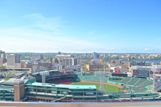 a view of a city from a dining room with a table and chairs