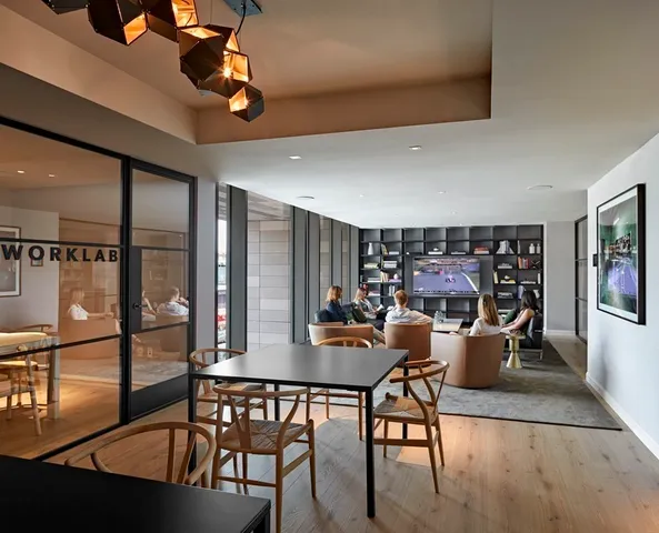 a view of a dining room with furniture a chandelier and wooden floor