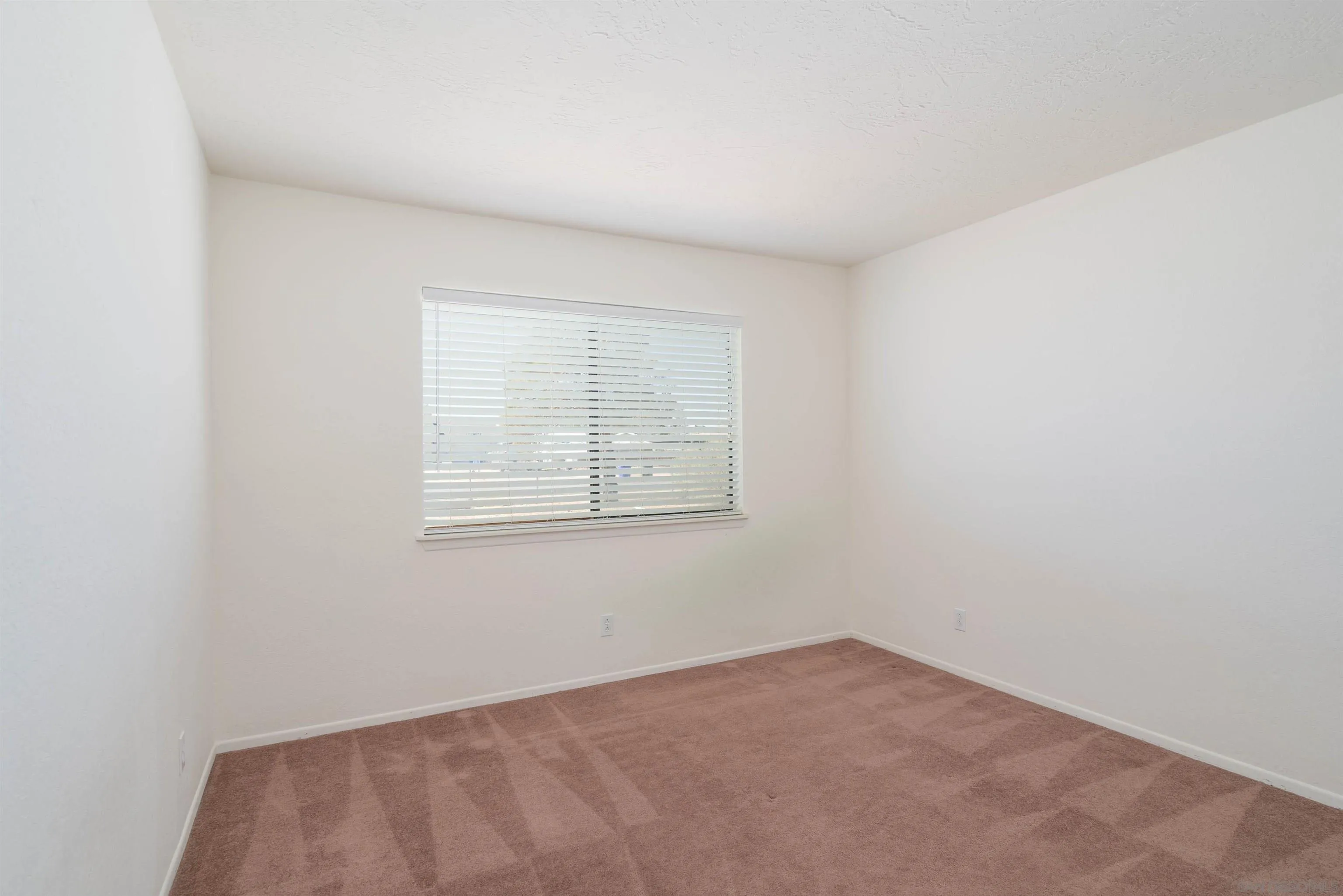 11341 Chimayo Road Apple Valley, CA 92308 - Photo 11 of 27 an empty room with a window