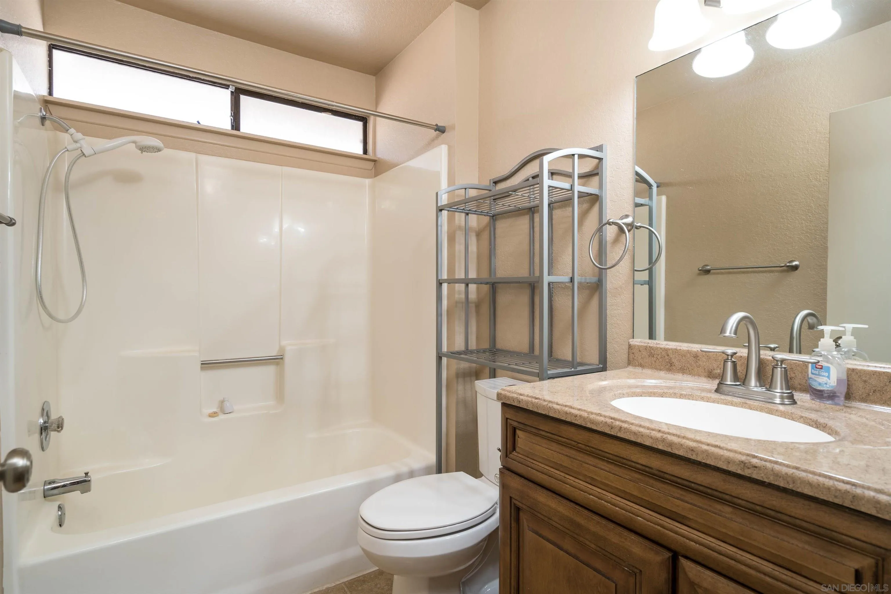 11341 Chimayo Road Apple Valley, CA 92308 - Photo 14 of 27 a bathroom with a granite countertop sink a toilet and shower