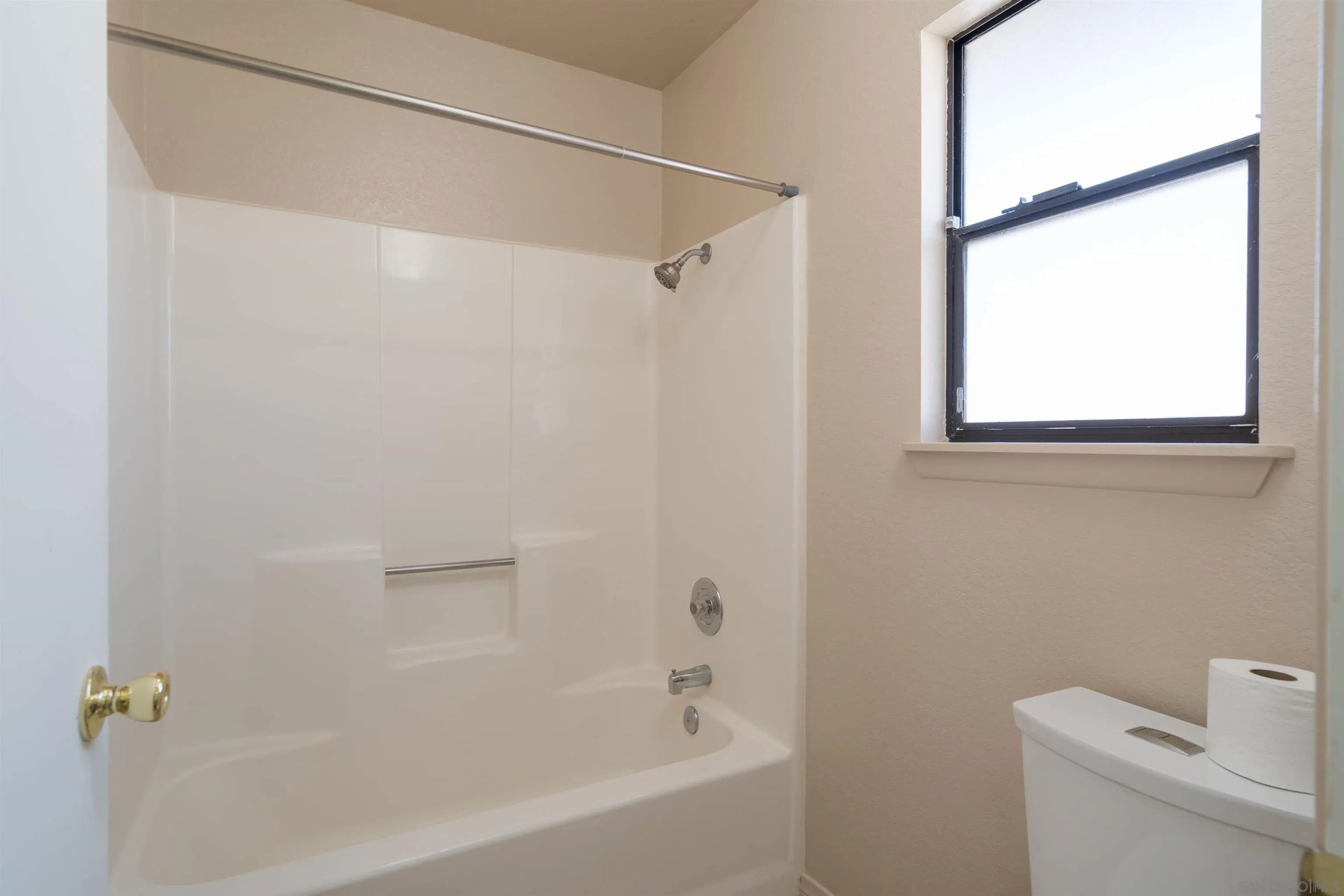 11341 Chimayo Road Apple Valley, CA 92308 - Photo 15 of 27 a white bath tub with a shower curtain