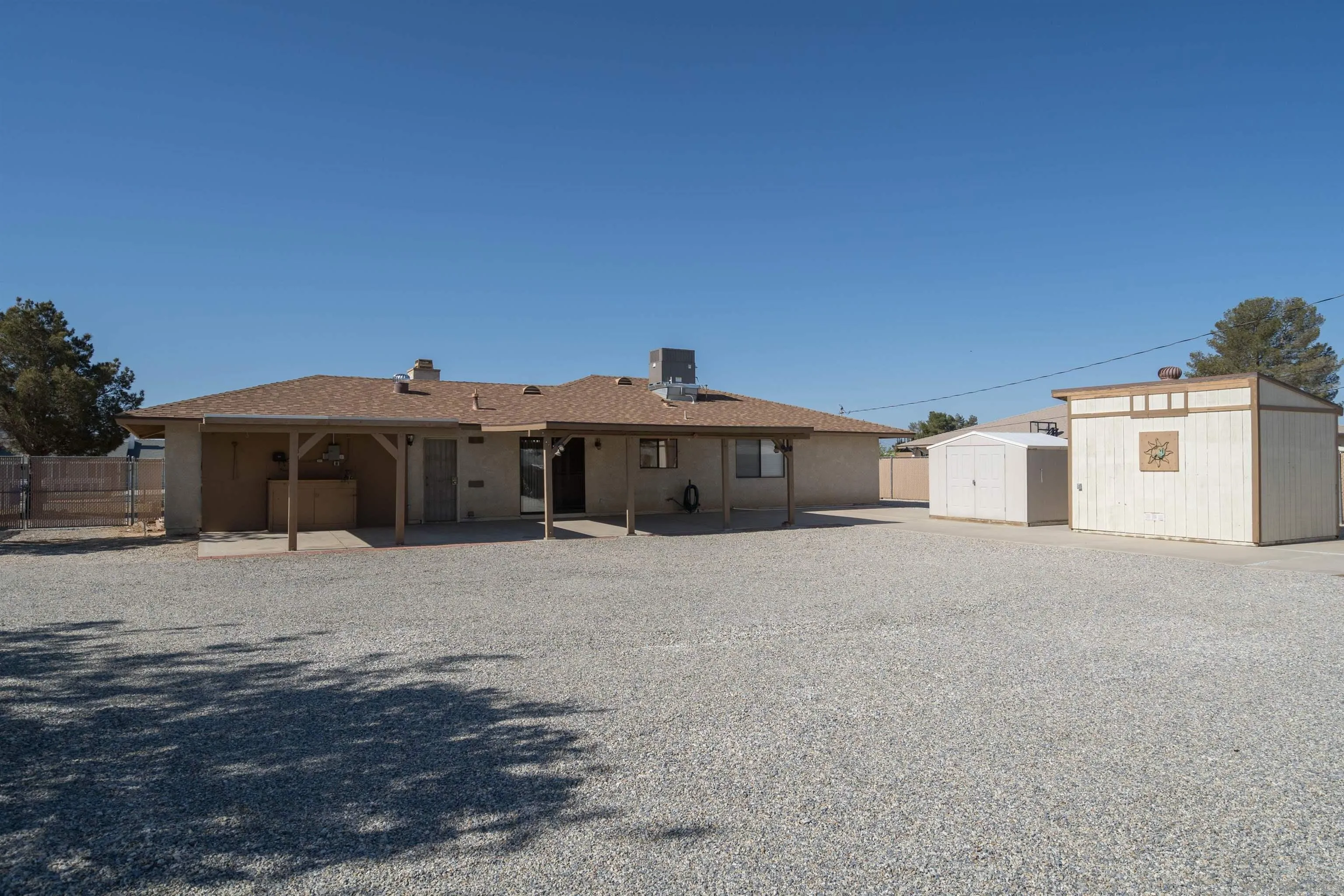 11341 Chimayo Road Apple Valley, CA 92308 - Photo 21 of 27 a big house with a large tree in front of it