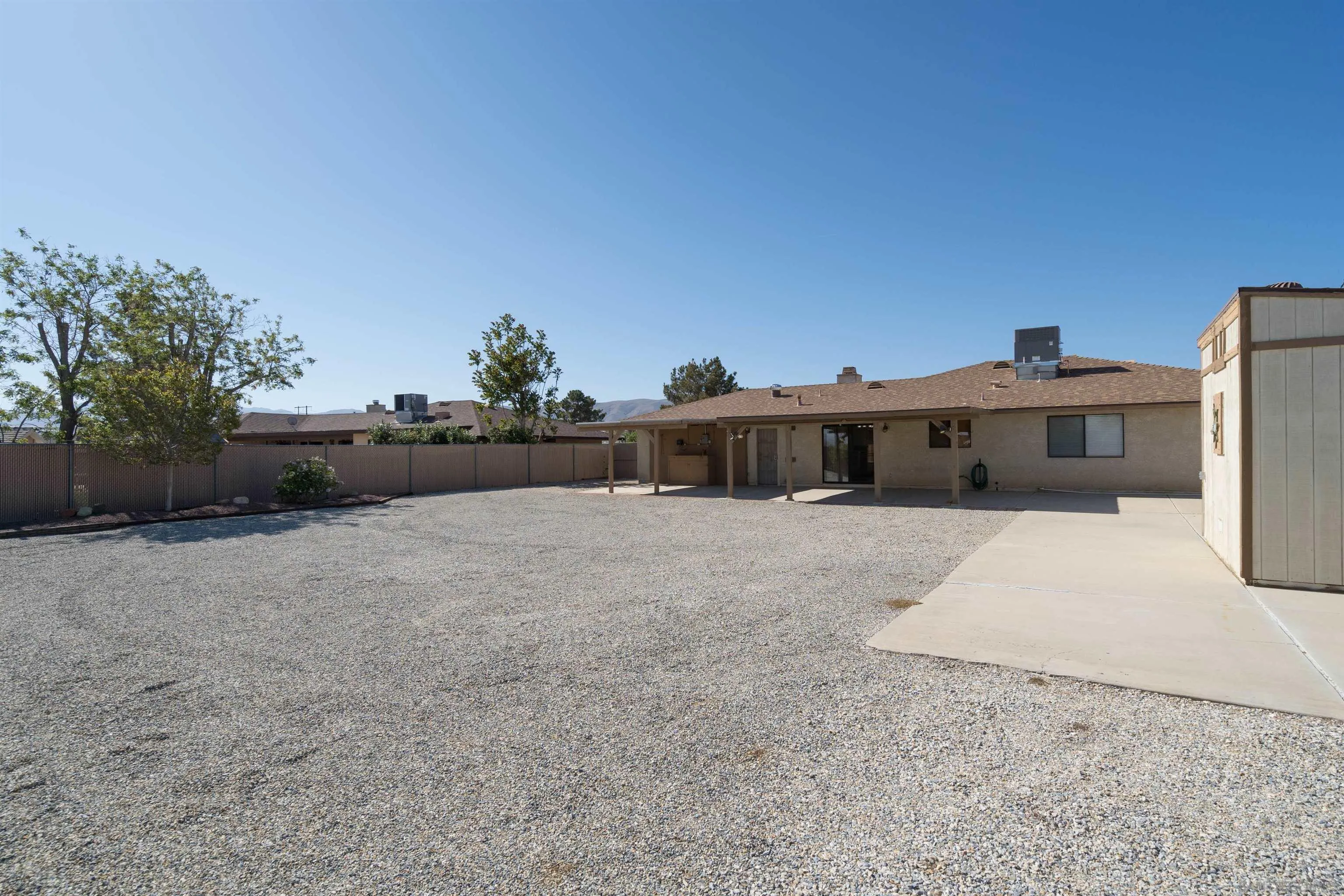 11341 Chimayo Road Apple Valley, CA 92308 - Photo 22 of 27 a view of a house with a backyard