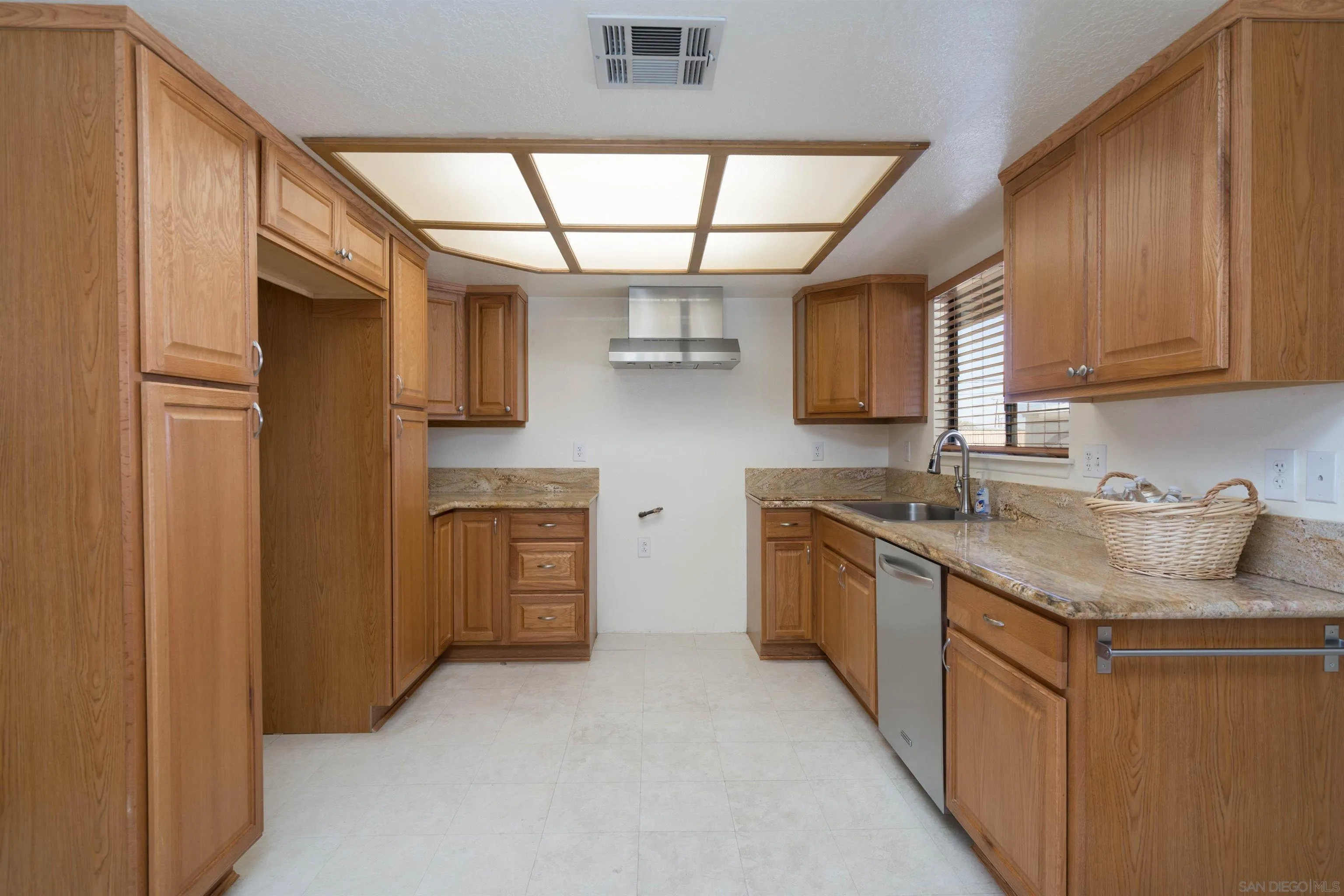 11341 Chimayo Road Apple Valley, CA 92308 - Photo 5 of 27 a kitchen with stainless steel appliances granite countertop a sink stove and refrigerator