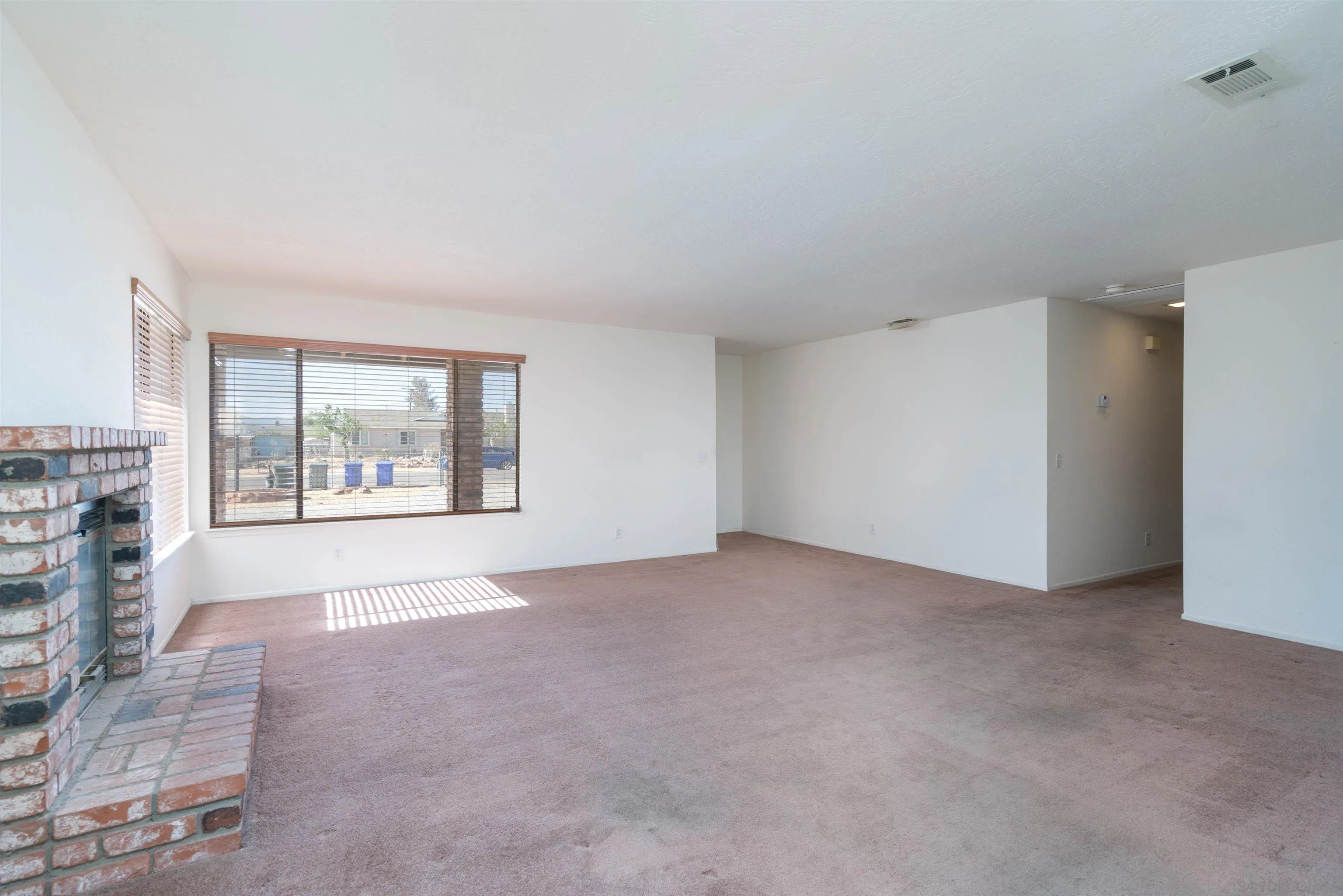 11341 Chimayo Road Apple Valley, CA 92308 - Photo 7 of 27 a view of an empty room with a window