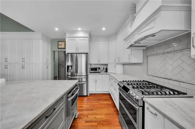 a bedroom with a bed couch and a flat tv screen on the dresser