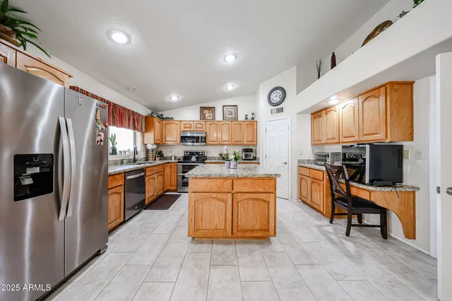 a large kitchen with stainless steel appliances lots of counter top space