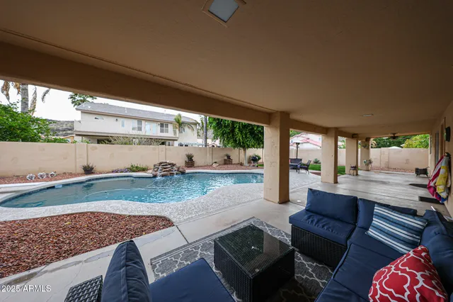 a view of a patio with couches table and chairs and potted plants