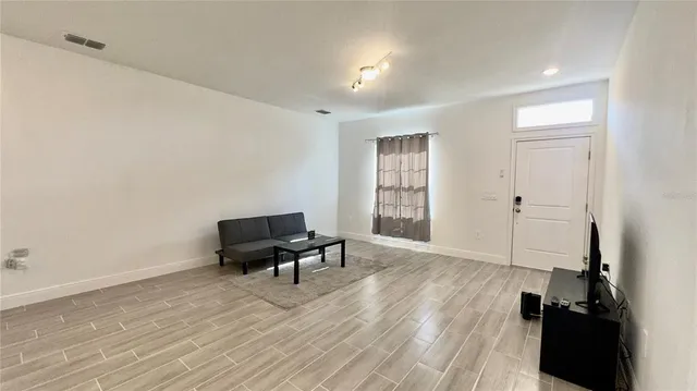 a view of a workspace with furniture and wooden floor