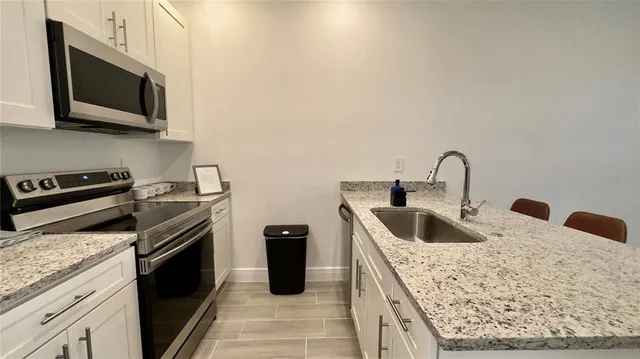 a kitchen with a sink stove and microwave