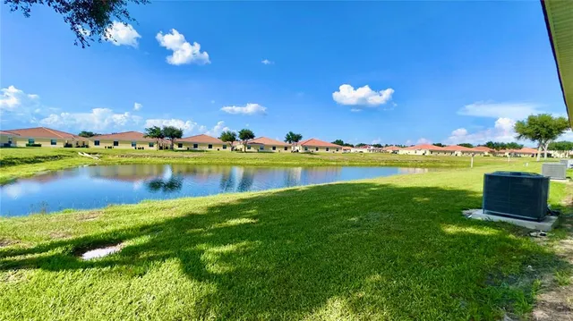 a view of a lake with houses in the back