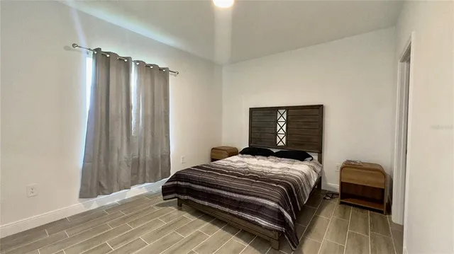 a bedroom with a bed and a window