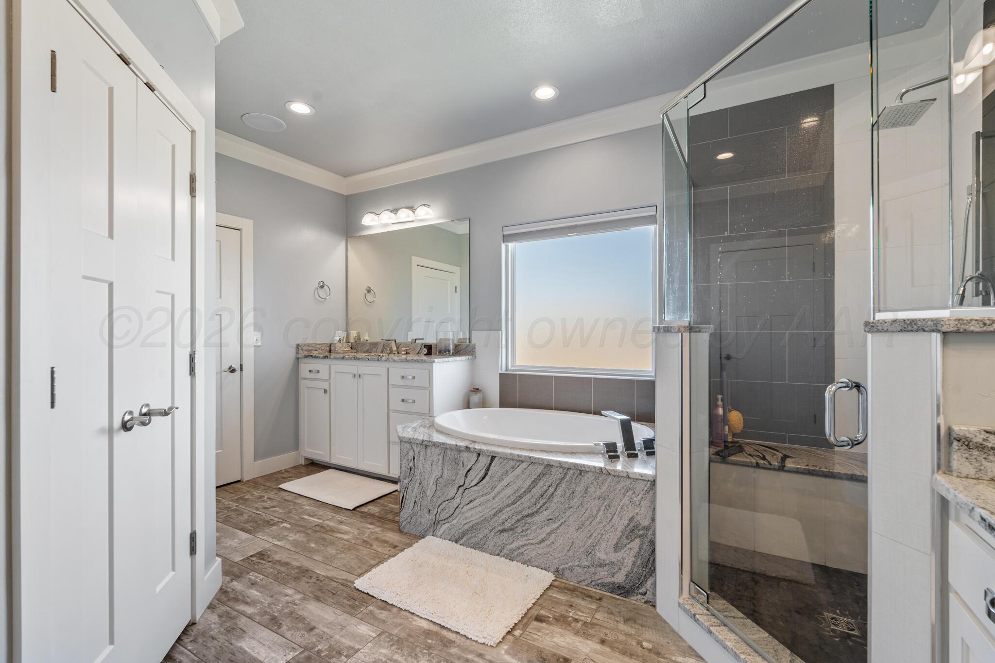 6550 Arnot Road Amarillo, TX 79119 - Photo 16 of 19 a bathroom with a granite countertop sink mirror and shower