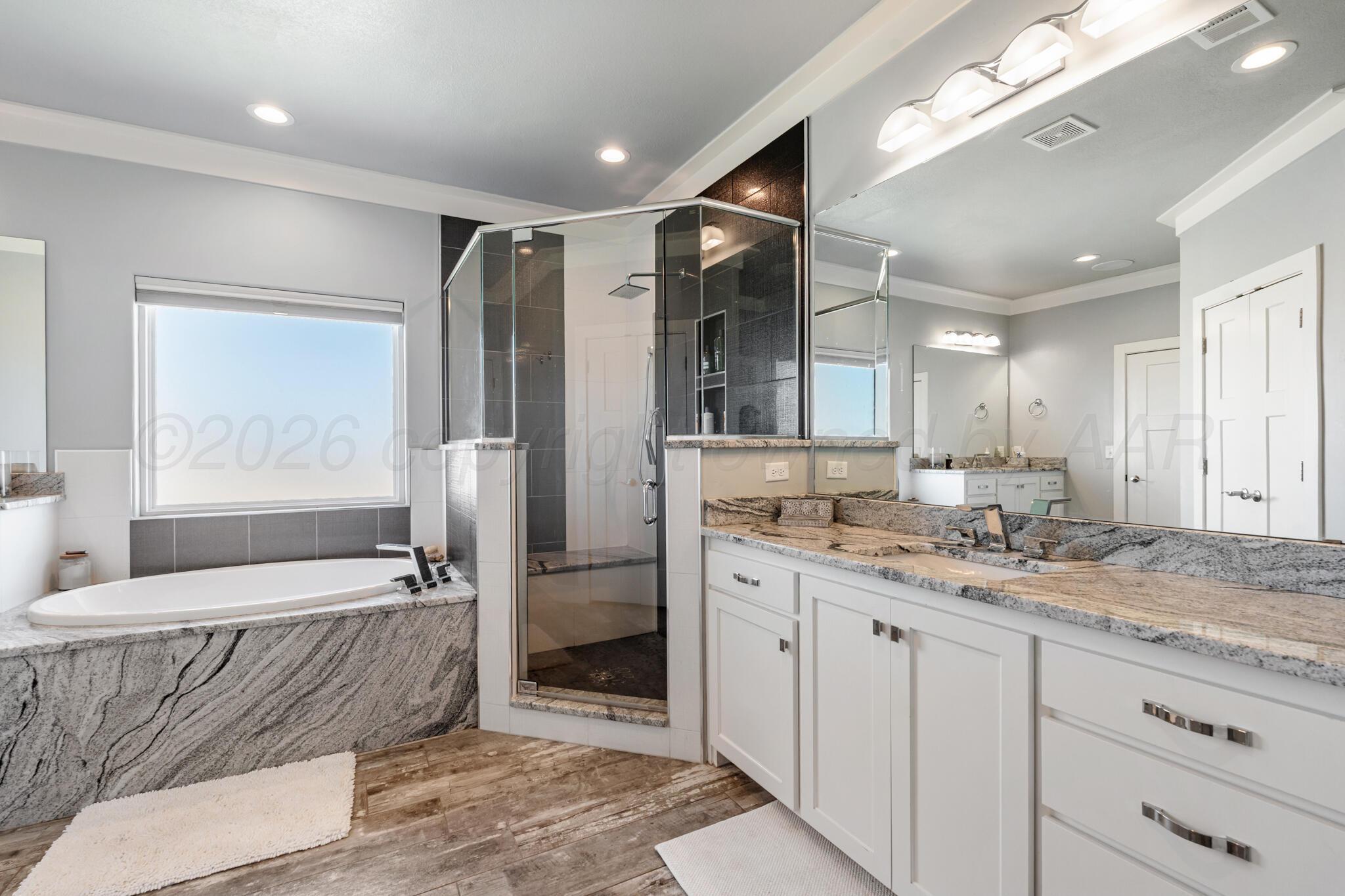 6550 Arnot Road Amarillo, TX 79119 - Photo 17 of 19 a bathroom with a granite countertop sink mirror and shower