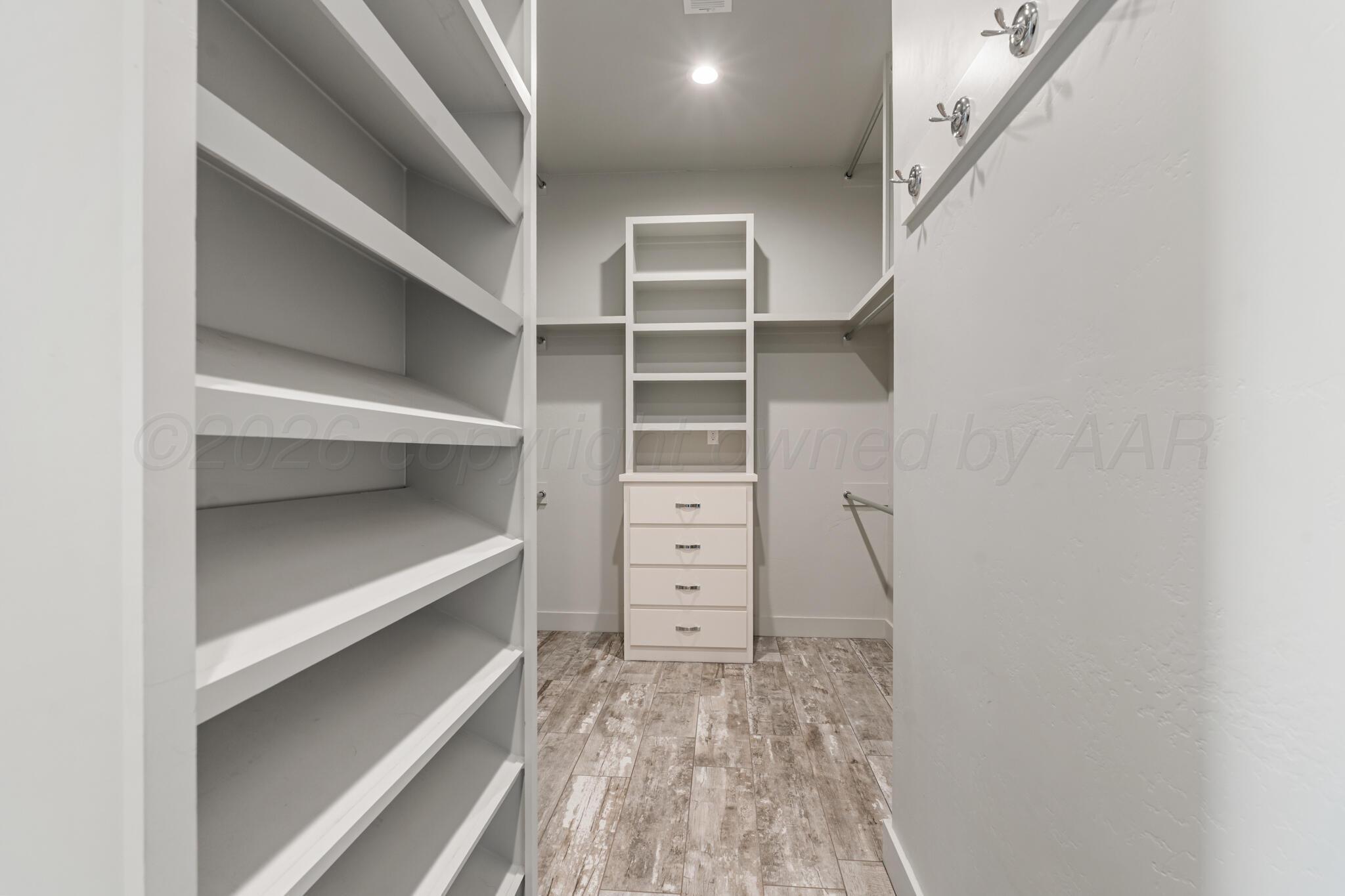 6550 Arnot Road Amarillo, TX 79119 - Photo 18 of 19 a view of walk in closet with empty racks