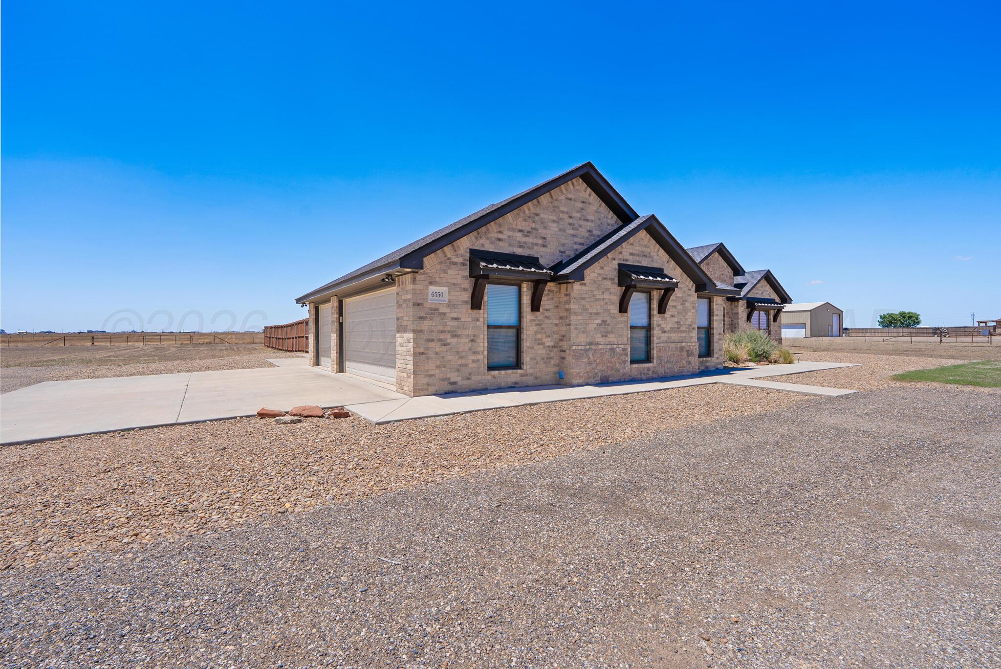 6550 Arnot Road Amarillo, TX 79119 - Photo 2 of 19 a view of a house with a yard