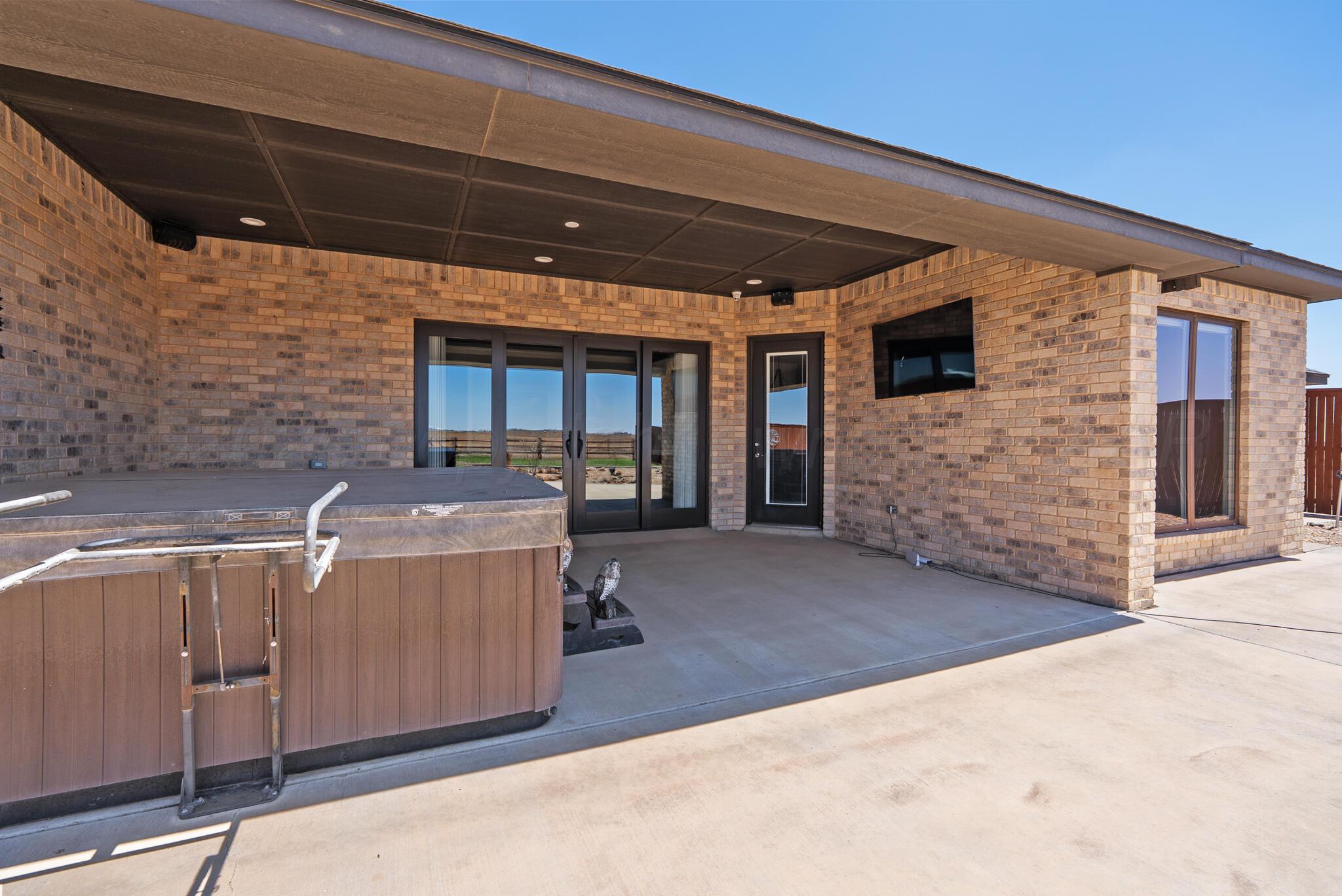6550 Arnot Road Amarillo, TX 79119 - Photo 5 of 19 a backyard of a house with barbeque oven and outdoor seating