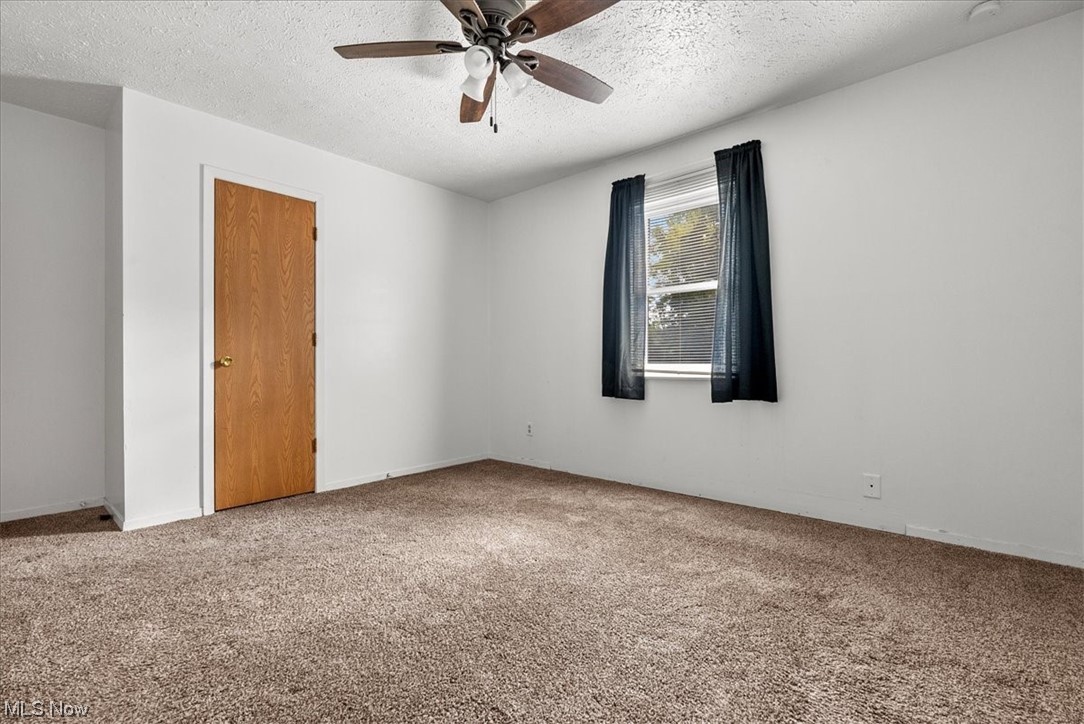 1827 Barth Road Belpre, OH 45714 - Photo 23 of 31 Carpeted empty room with ceiling fan and a textured ceiling