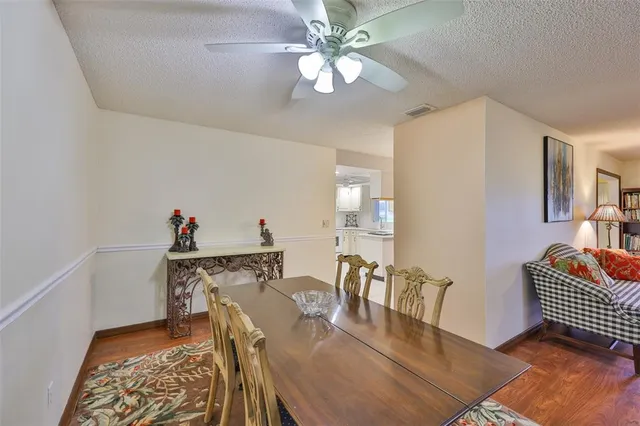 a view of a dining room with furniture and chandelier