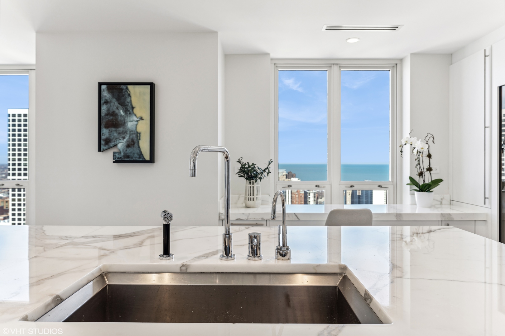 11 East Walton Street, Unit 4202 Chicago, IL 60611 - Photo 14 of 48 a kitchen with a faucet a sink and a window