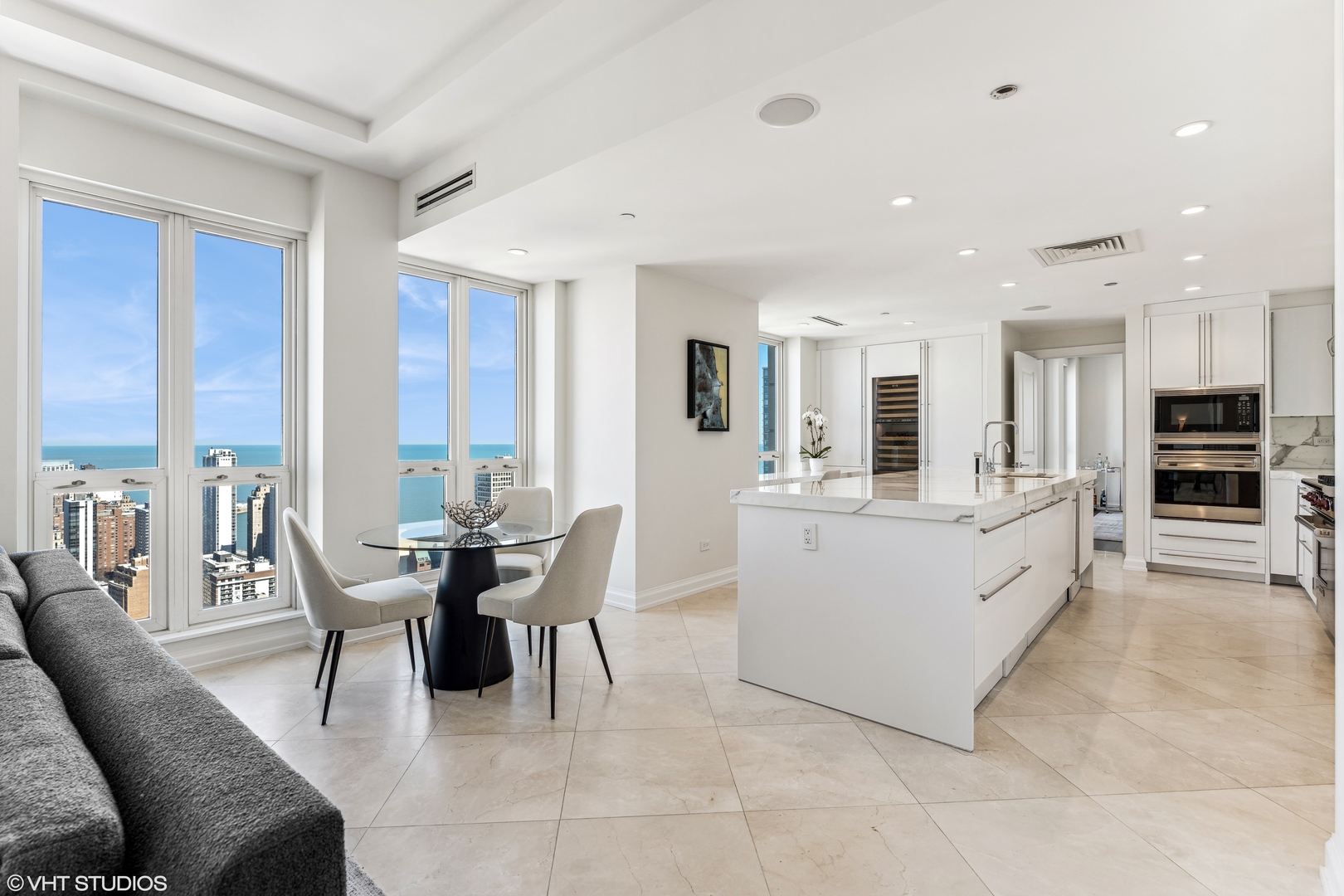 11 East Walton Street, Unit 4202 Chicago, IL 60611 - Photo 17 of 48 a large white kitchen with furniture a large window and a counter space