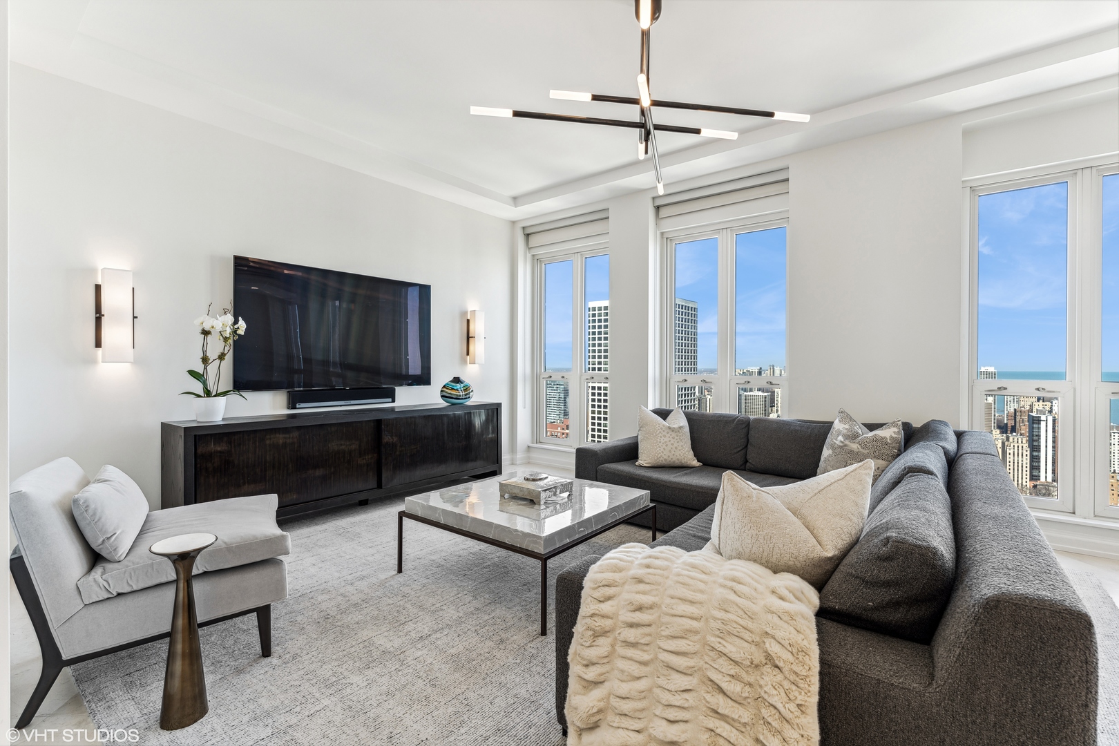 11 East Walton Street, Unit 4202 Chicago, IL 60611 - Photo 20 of 48 a living room with furniture and a flat screen tv