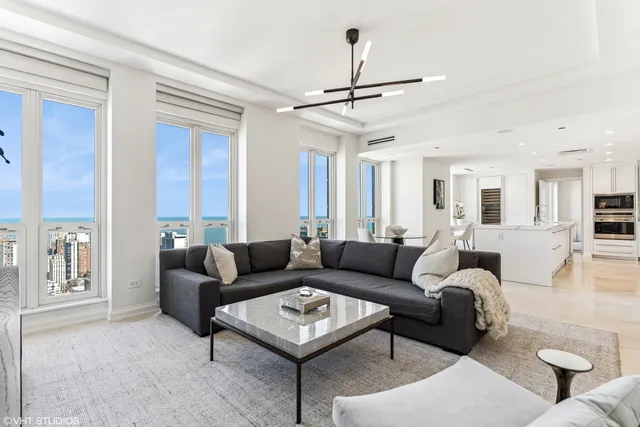 a living room with furniture a ceiling fan and a window
