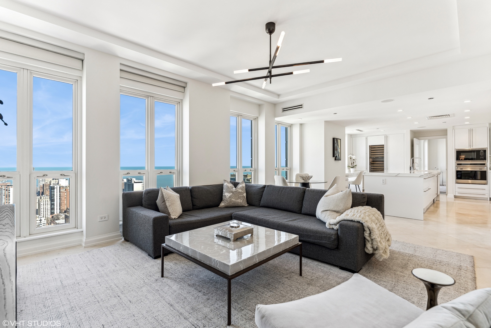 11 East Walton Street, Unit 4202 Chicago, IL 60611 - Photo 21 of 48 a living room with furniture a ceiling fan and a window