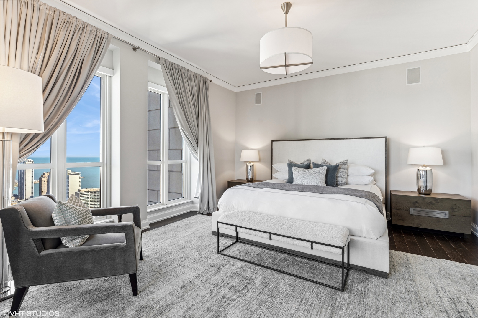 11 East Walton Street, Unit 4202 Chicago, IL 60611 - Photo 23 of 48 a bedroom with a bed wooden floor and a large window