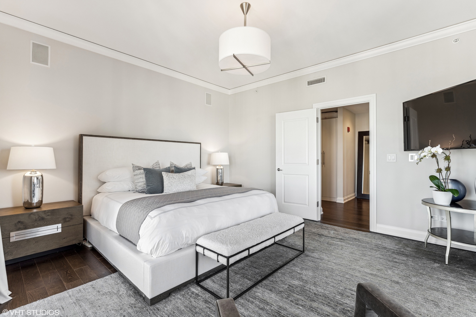 11 East Walton Street, Unit 4202 Chicago, IL 60611 - Photo 24 of 48 a bedroom with a bed and a flat screen tv