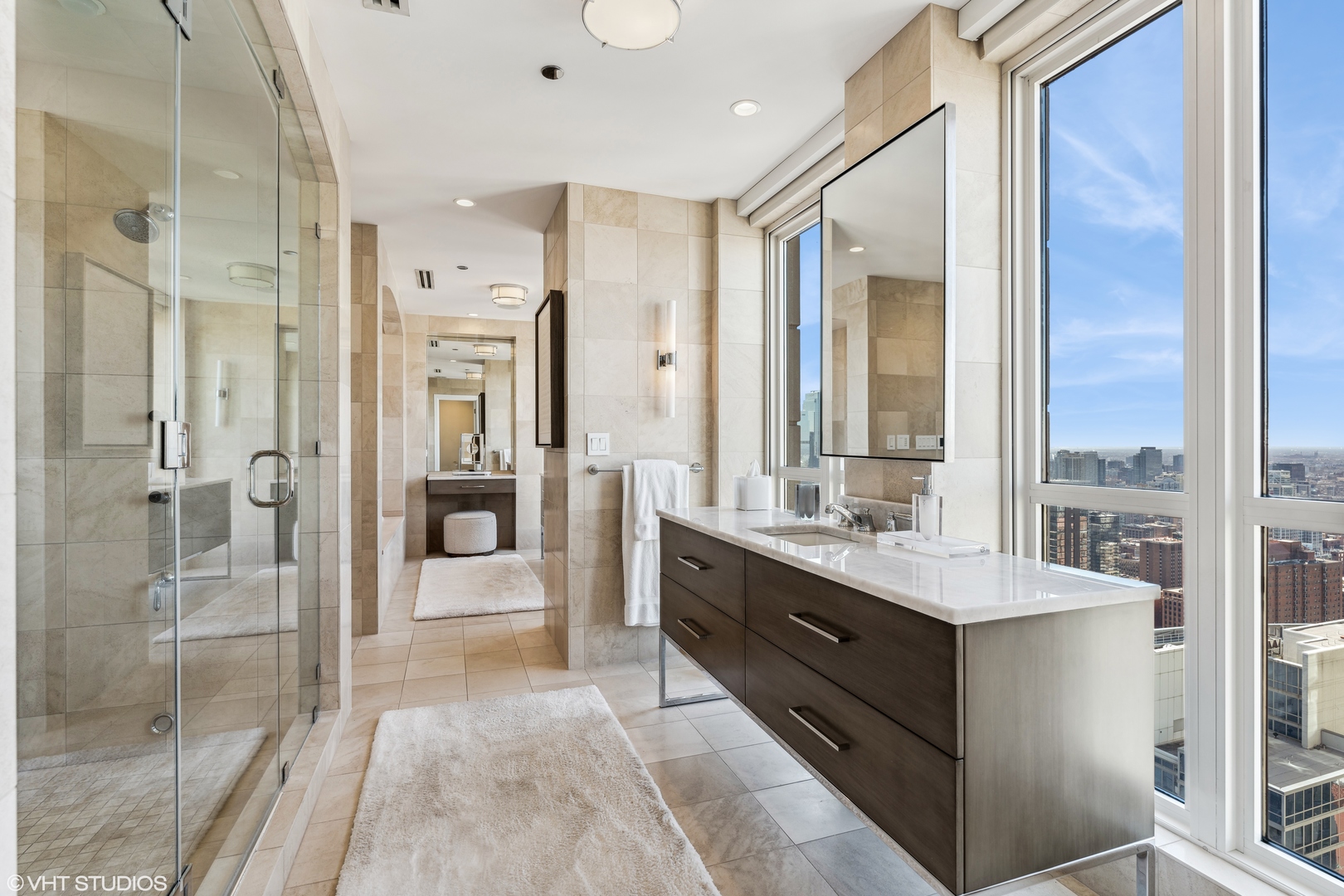 11 East Walton Street, Unit 4202 Chicago, IL 60611 - Photo 26 of 48 a bathroom with a double vanity sink mirror and shower