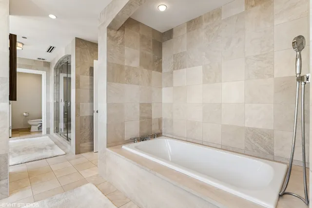 a bathroom with a bathtub and a shower