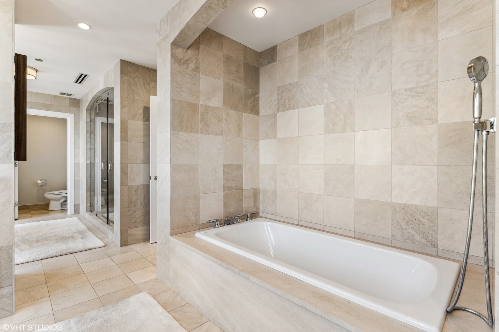 11 East Walton Street, Unit 4202 Chicago, IL 60611 - Photo 28 of 48 a bathroom with a bathtub and a shower