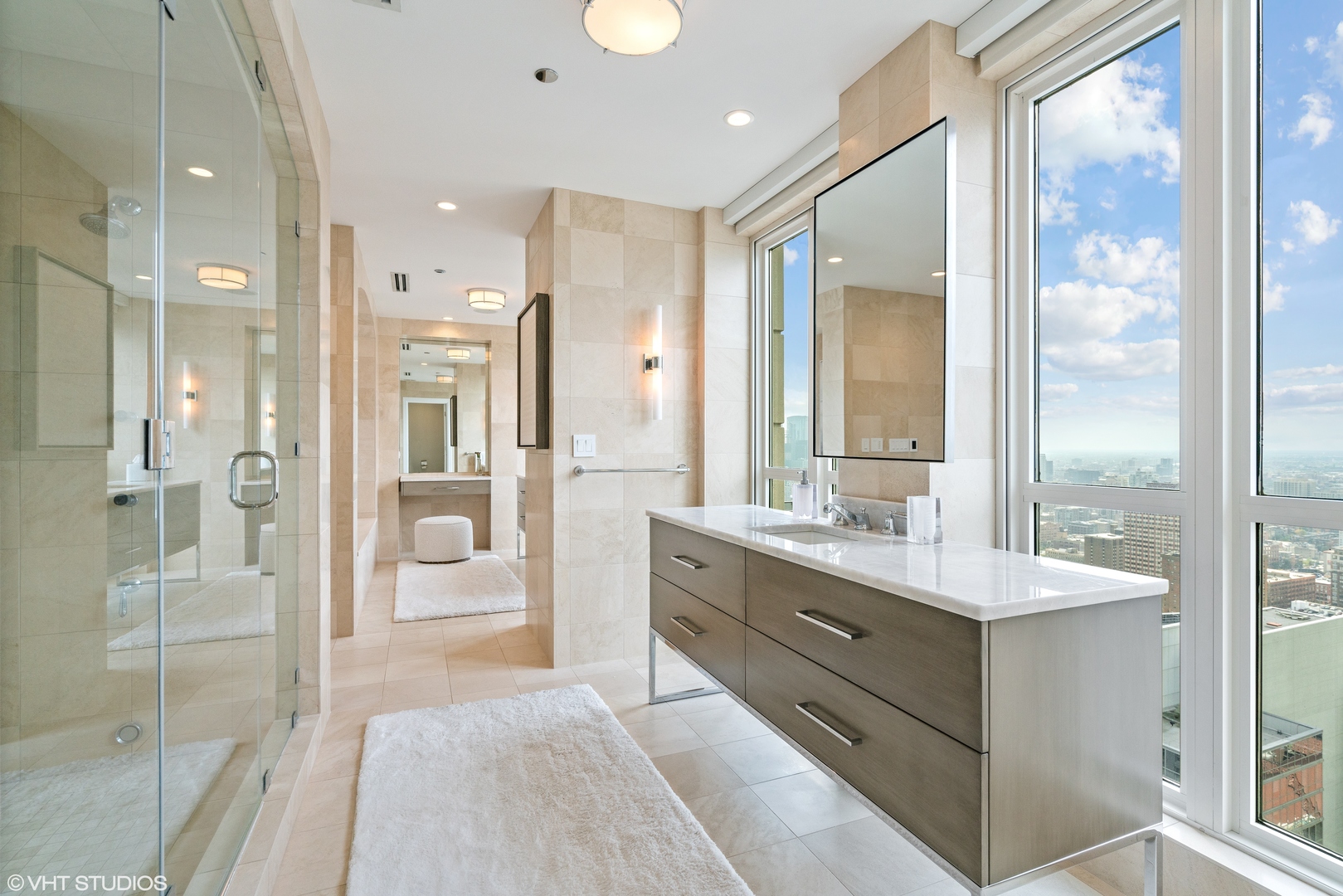 11 East Walton Street, Unit 4202 Chicago, IL 60611 - Photo 29 of 48 a spacious bathroom with a shower sink and mirror