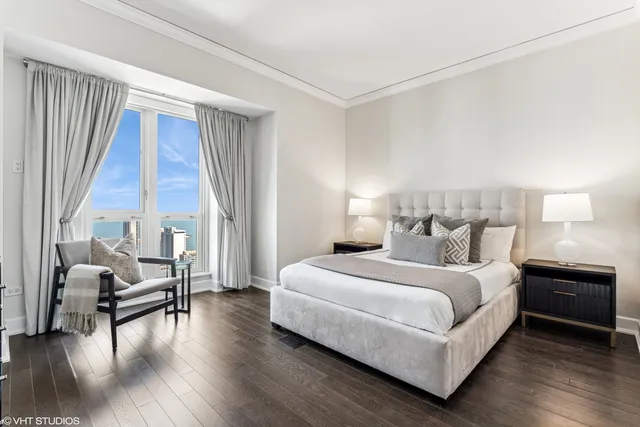 a bedroom with a bed and a large window