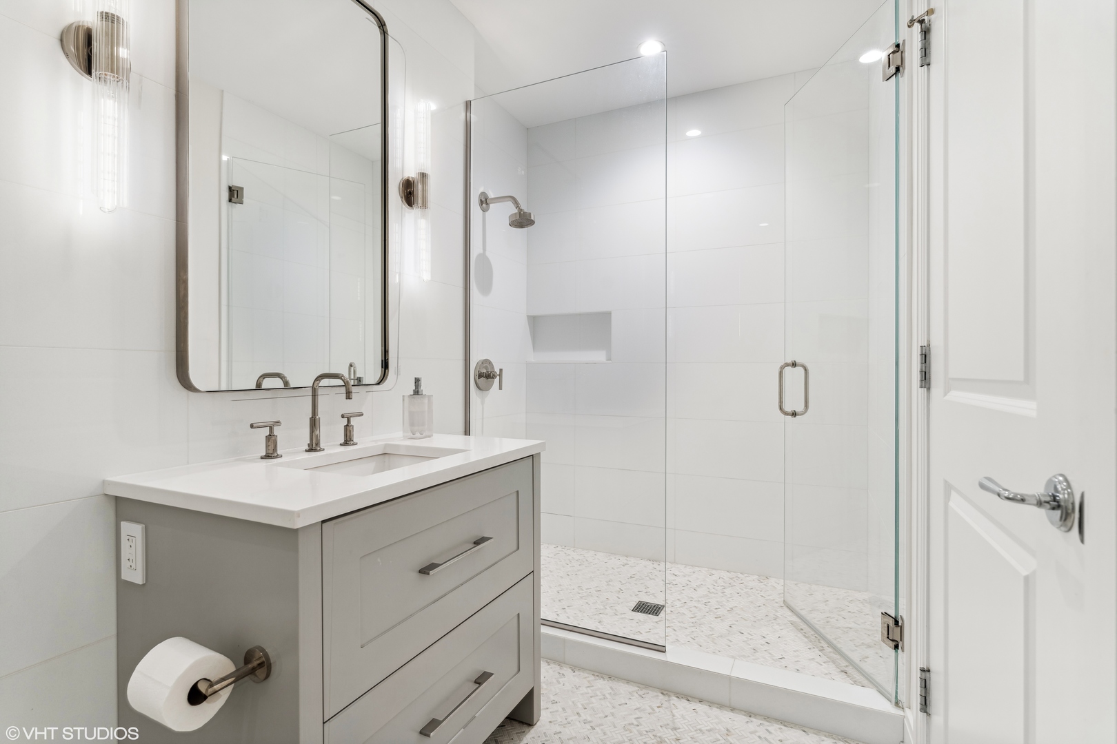 11 East Walton Street, Unit 4202 Chicago, IL 60611 - Photo 33 of 48 a bathroom with a shower sink vanity and mirror