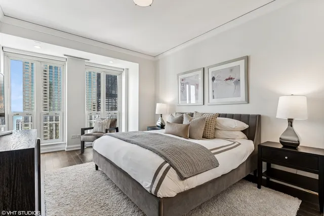 a bedroom with a bed lamp and window