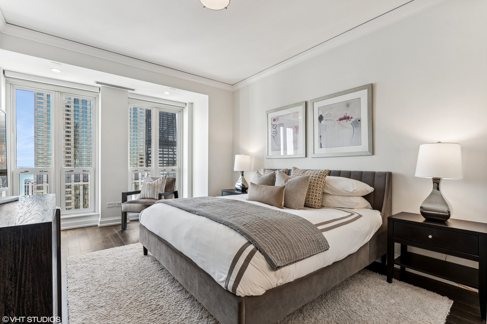 11 East Walton Street, Unit 4202 Chicago, IL 60611 - Photo 34 of 48 a bedroom with a bed lamp and window