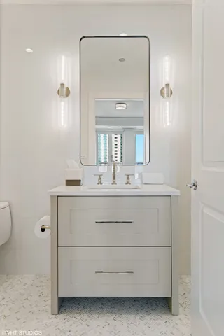a bathroom with a double vanity sink and mirror