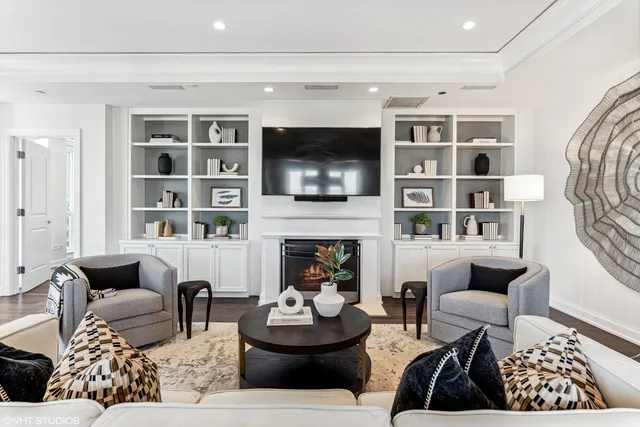 a living room with furniture a flat screen tv and a fireplace