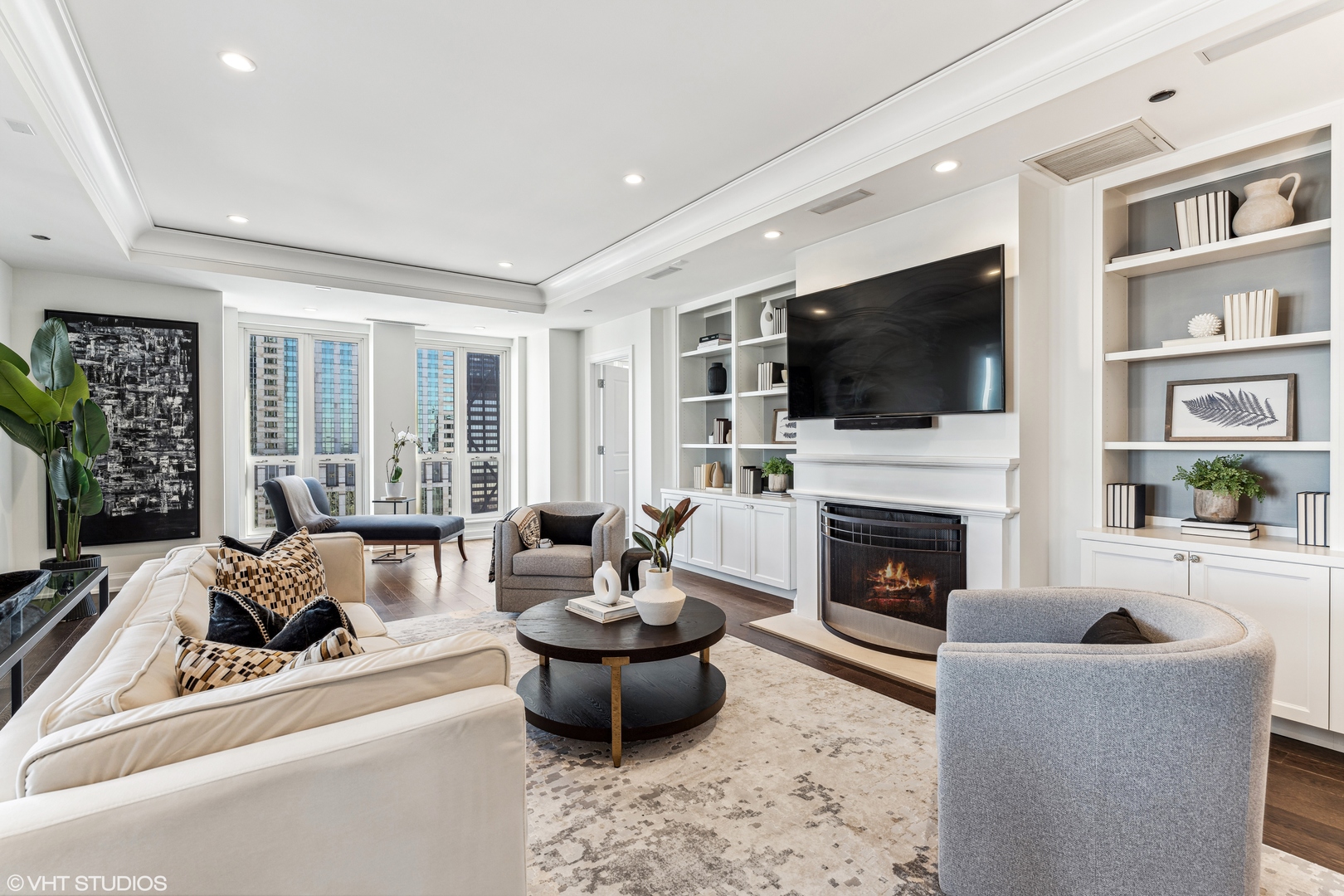 11 East Walton Street, Unit 4202 Chicago, IL 60611 - Photo 7 of 48 a living room with furniture a flat screen tv and a fireplace