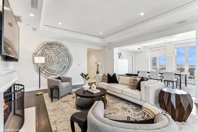 a living room with furniture and a mirror