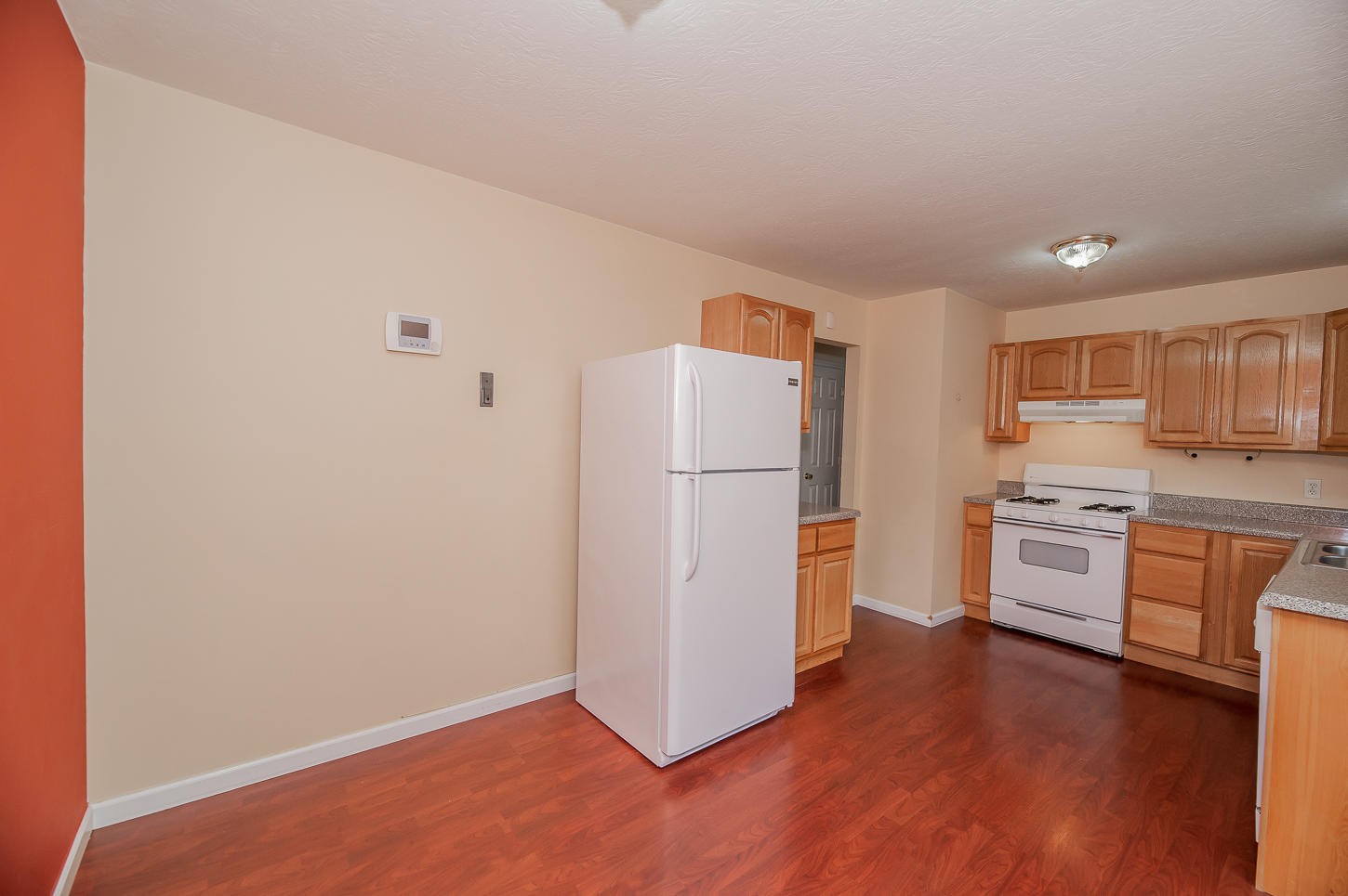 2224 Roundtree Road Knoxville, TN 37923 - Photo 8 of 22 a kitchen with a refrigerator a stove top oven a counter space and wooden floor