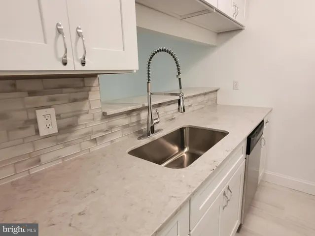 a kitchen with a sink and granite