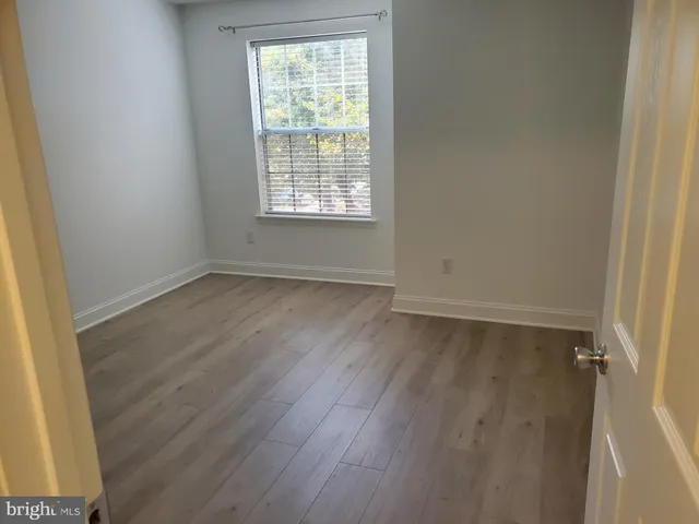 a bathroom with a granite countertop bathtub shower sink and toilet