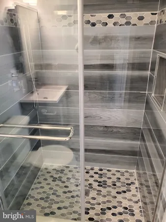 a view of walk in closet with wooden floor