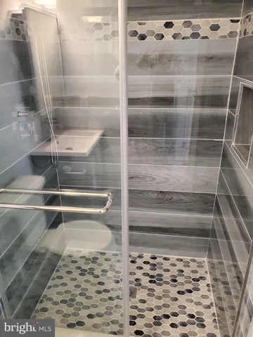 a view of walk in closet with wooden floor